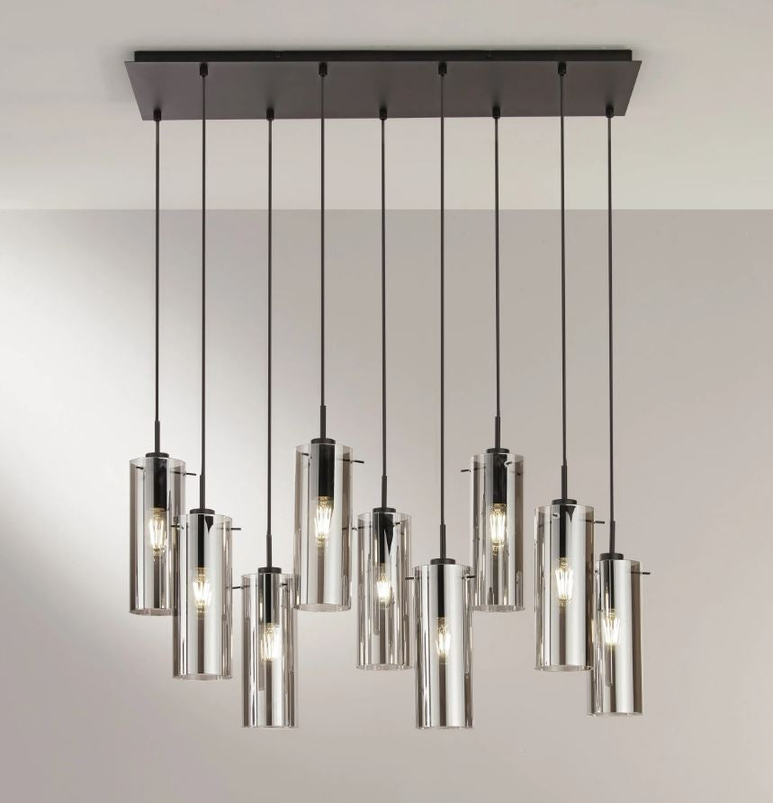 Sosp. 9 luci forme cilindriche in metallo nero con vetro fumè o metallo oro con vetro ambra 9XE27 non incl. MAGIC Sosp. 9 luci forme cilindriche in metallo nero con vetro fumè o metallo oro con vetro ambra 9XE27 non incl. MAGIC